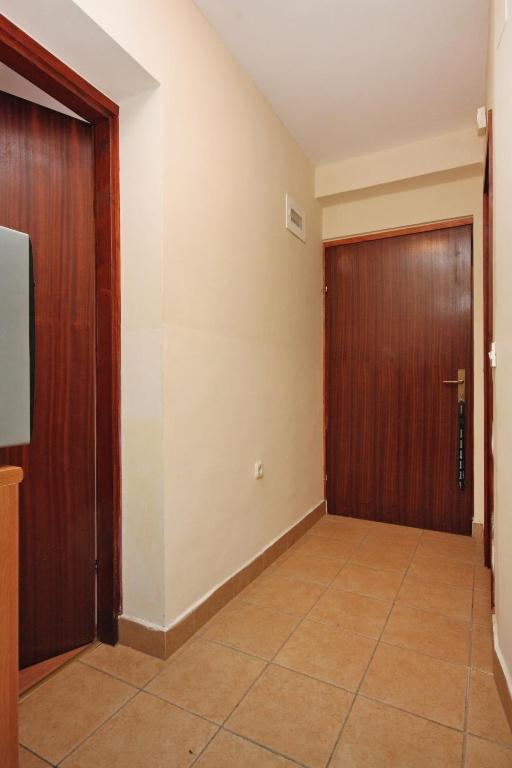 a hallway with a door and a tiled floor at Apartment Bibinje 5769a in Bibinje