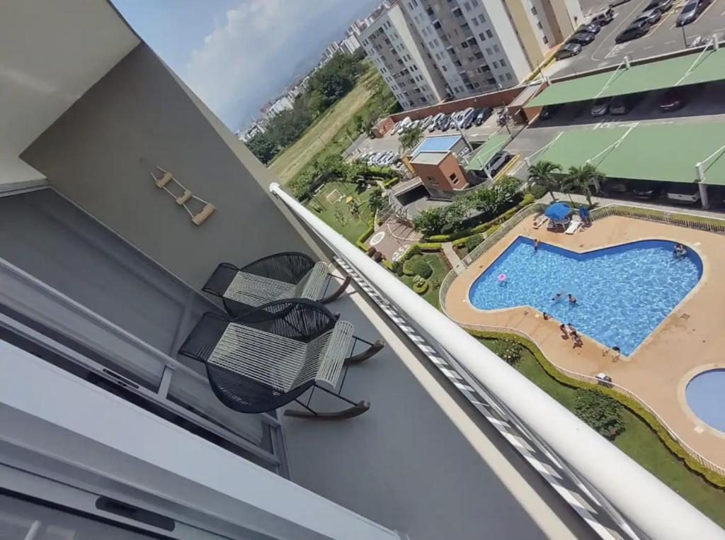 a view from the balcony of a condo with a swimming pool at Valle del lili cozy apartment in Cali