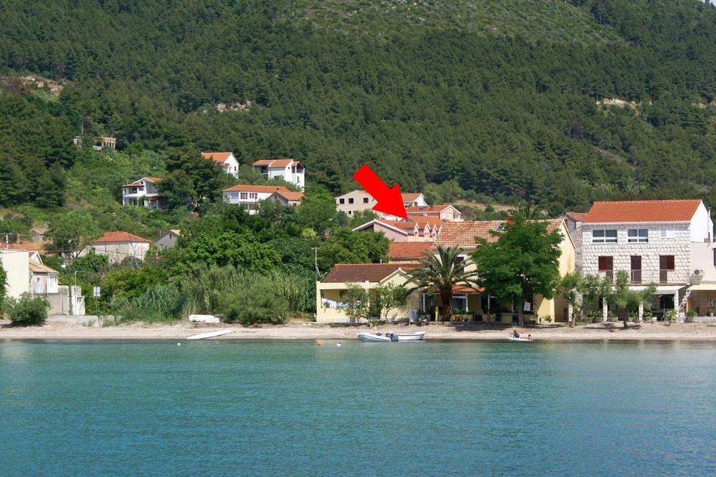 a small town on the shore of a body of water at Apartment Zuljana 4576a in Žuljana