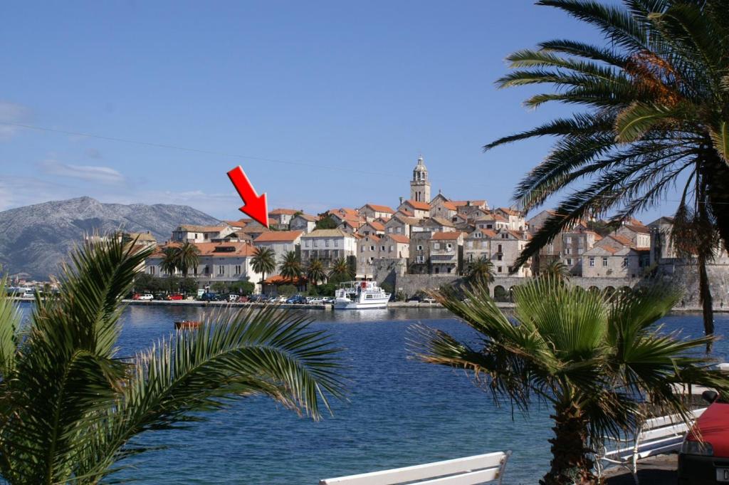 a view of a town with a river and palm trees at Apartments by the sea Korcula - 4450 in Korčula