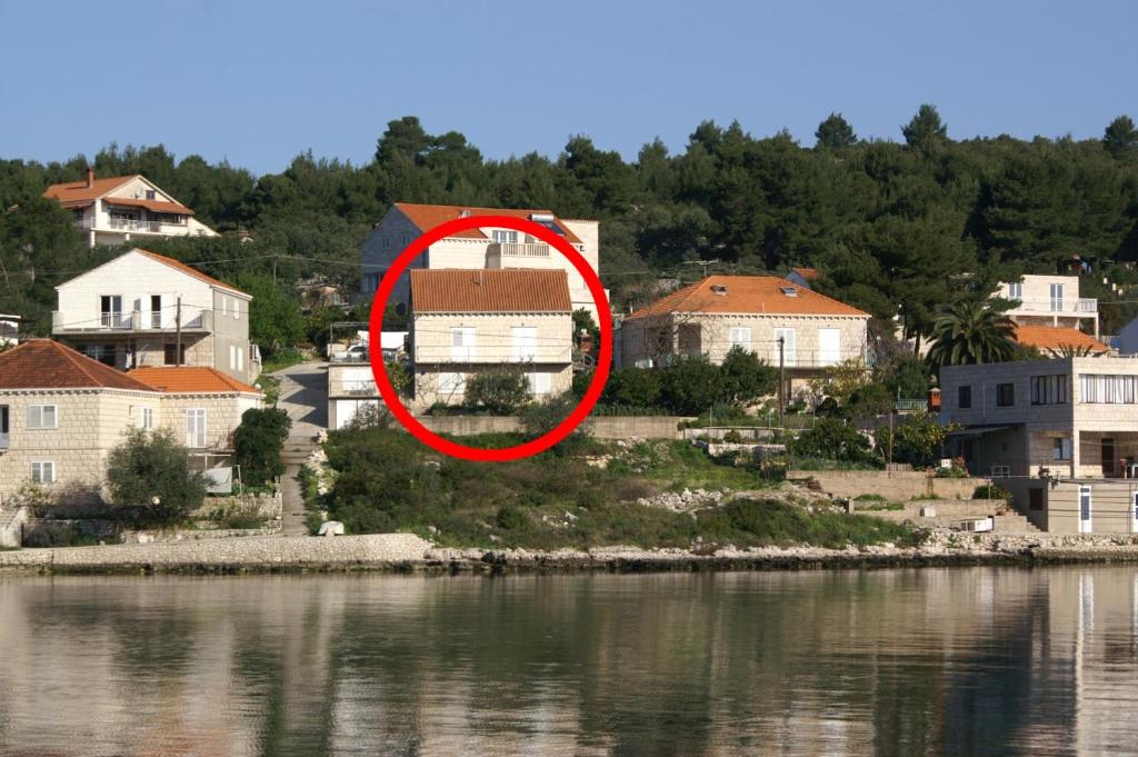 a house on an island next to a body of water at Apartments by the sea Lumbarda, Korcula - 4369 in Lumbarda