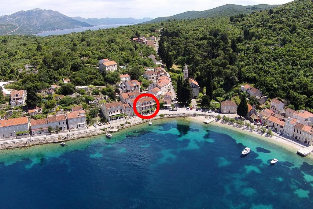 a red sign on a bridge over a body of water at Apartments and rooms by the sea Racisce, Korcula - 4341 in Račišće