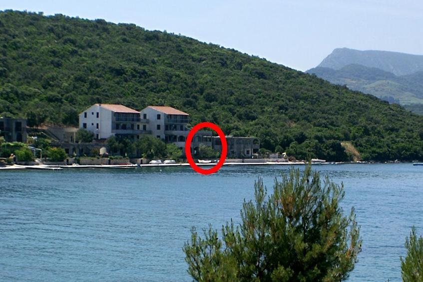 a red circle in the middle of a body of water at Apartments by the sea Luka Dubrava, Peljesac - 4568 in Janjina