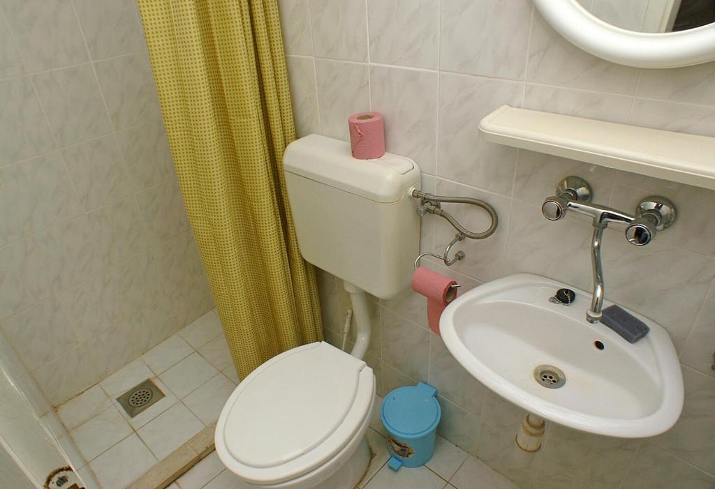 a bathroom with a toilet and a sink at Family Room Drace 4550a in Drače