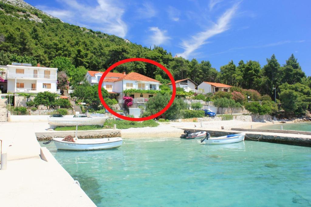 eine Gruppe von Booten im Wasser neben Häusern in der Unterkunft Apartments by the sea Kuciste - Perna, Peljesac - 4544 in Kučište