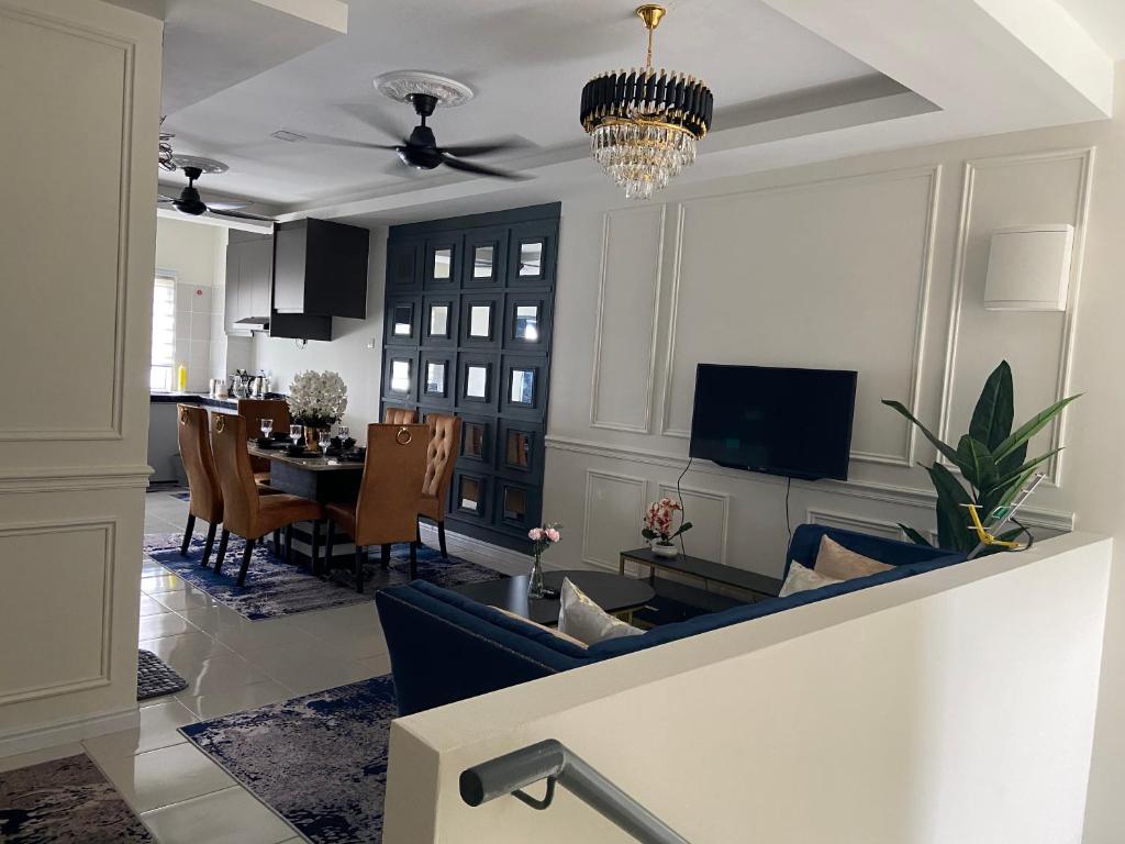 a living room with a couch and a dining room at Cheerfull3 bedroom townhouse Terrace in Kampung Dengkil