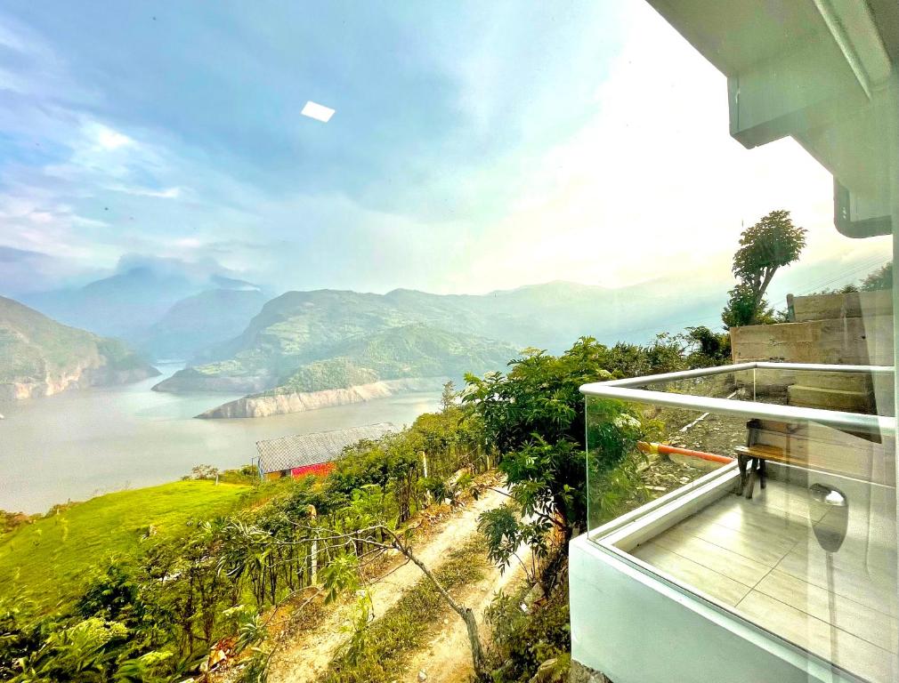 a house with a view of a river and mountains at La Vista EcoHouse in Macanal