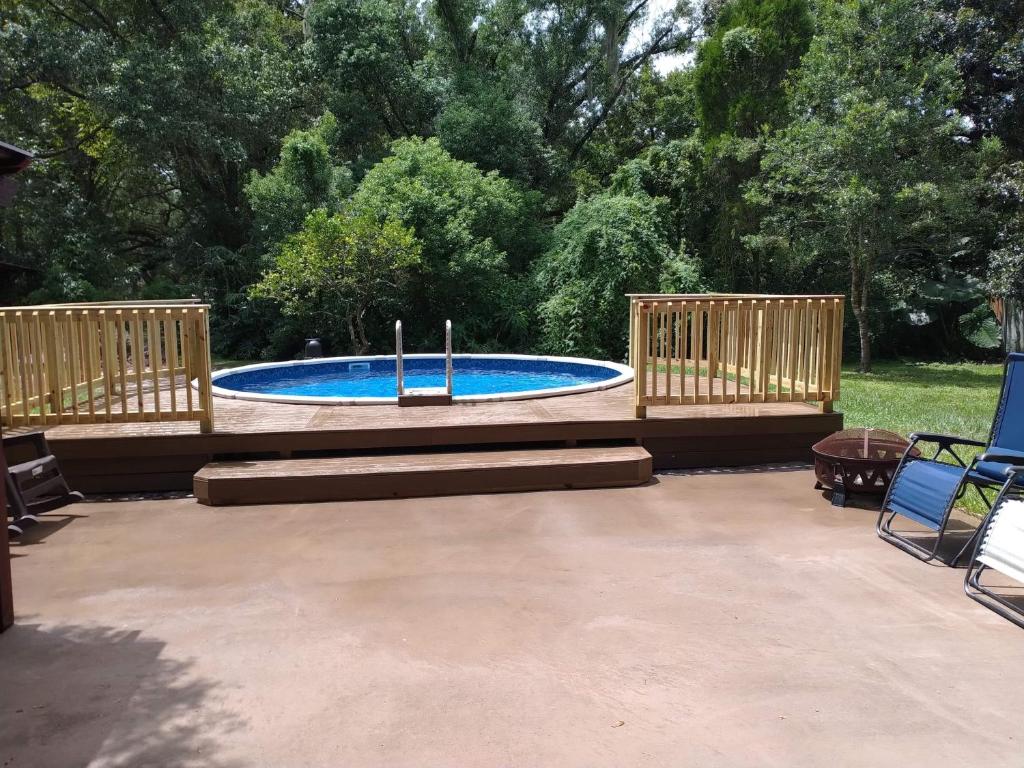 a patio with a swimming pool with two wooden decks at Large Tampa Home*Sleeps 16*Near Busch Gardens &USF in Tampa