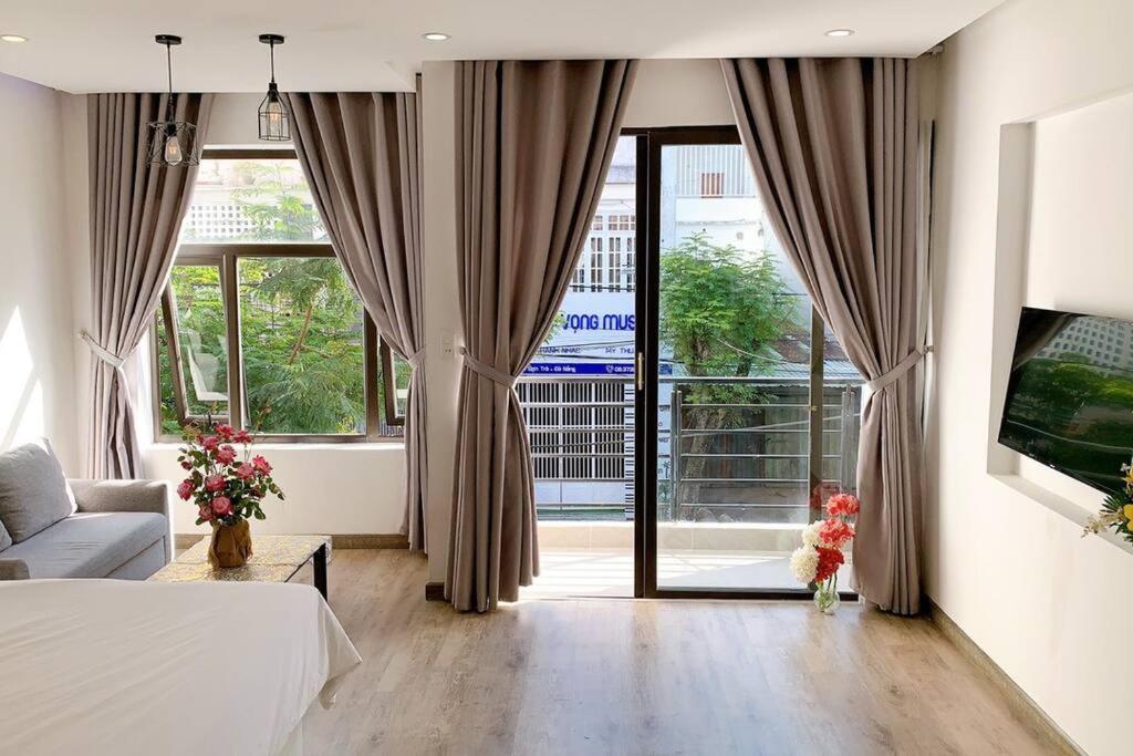 a bedroom with a bed and a large window at POOL Seaview 3A - Deluxe Apartment BALCONY in Da Nang