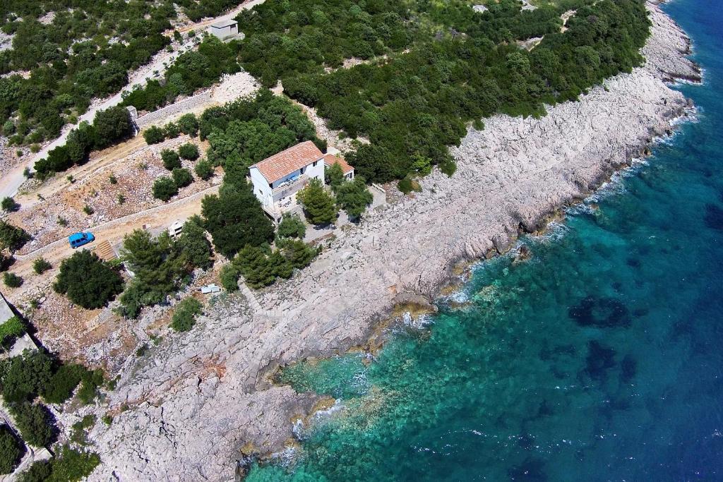 an island with a house and the ocean at Apartments by the sea Dingac - Potocine, Peljesac - 4533 in Potomje