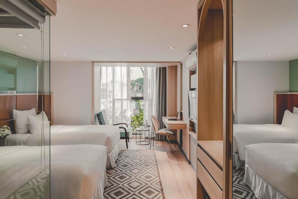 Postel nebo postele na pokoji v ubytování Hanoi Le Jardin Hotel & Spa