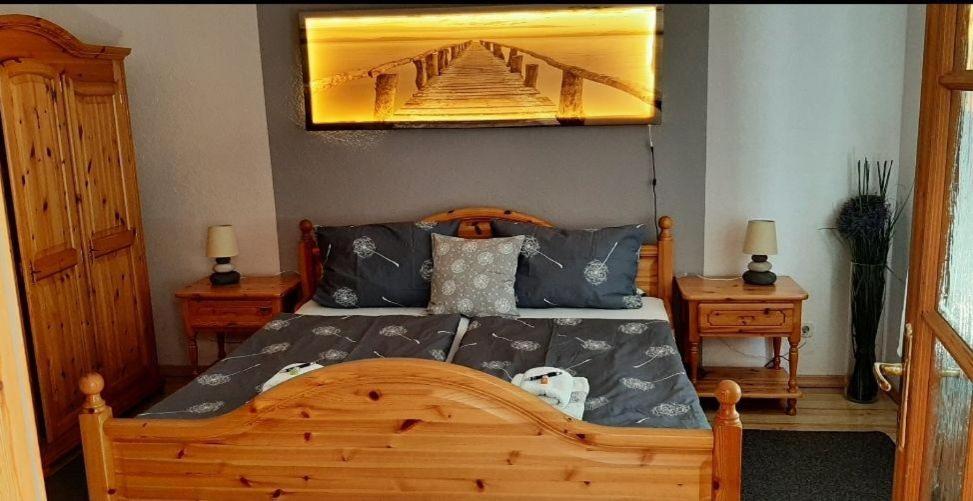 a bedroom with a wooden bed with a painting on the wall at Mira in Timmendorfer Strand