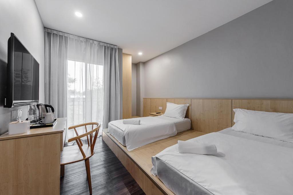 Postel nebo postele na pokoji v ubytování Hako Hotel Taman U
