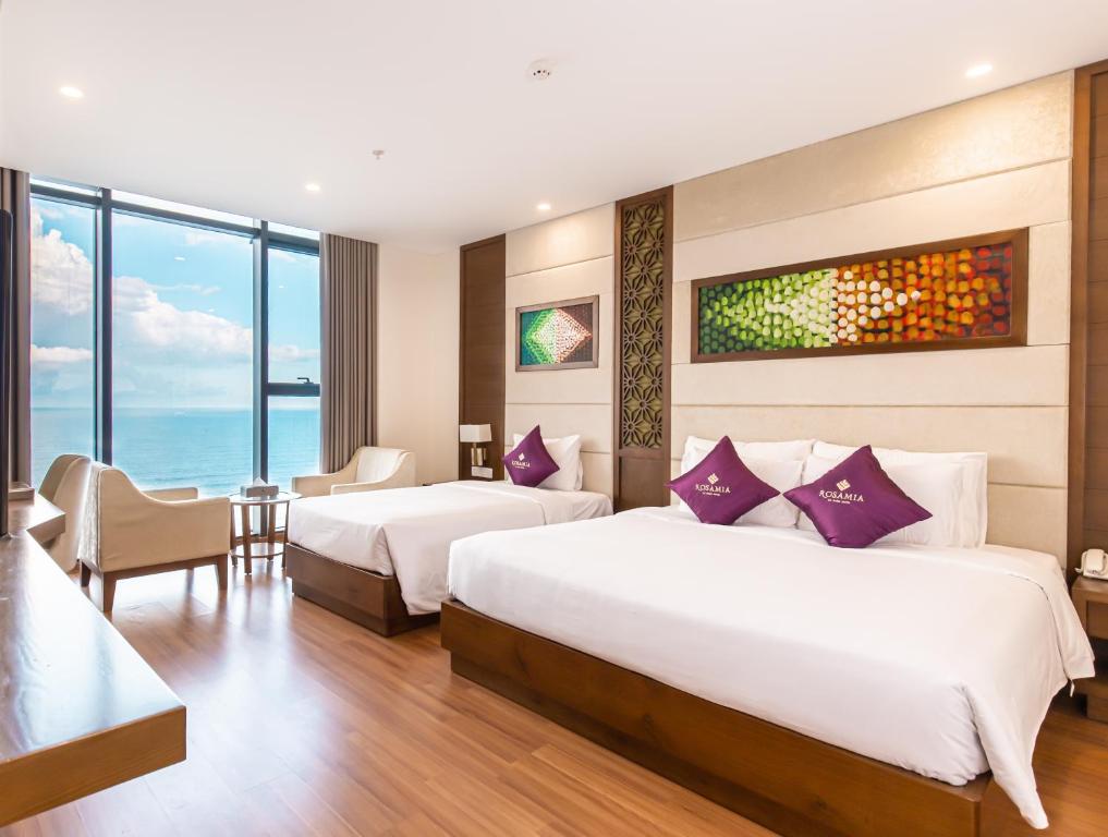 Postel nebo postele na pokoji v ubytování Rosamia Da Nang Hotel