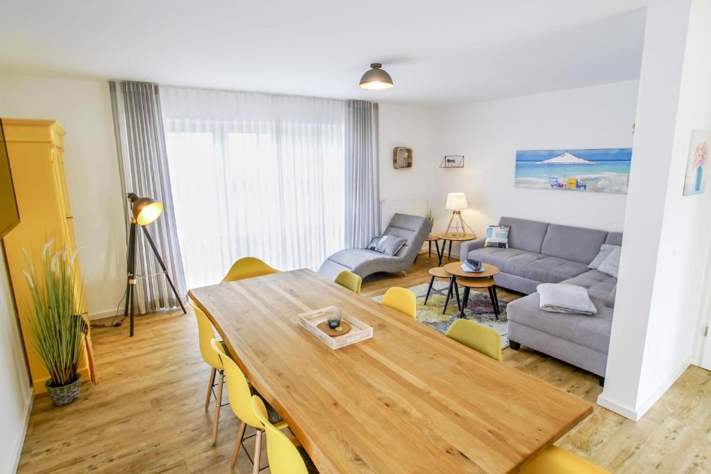 a living room with a table and a couch at Ferienhaus 16 "Gut Tossens" in Tossenserdeich