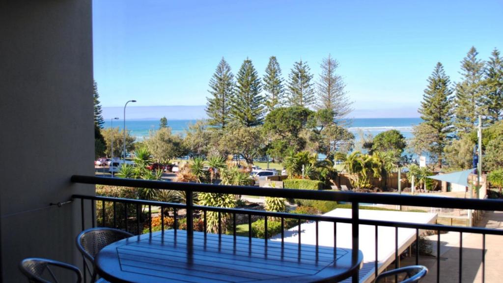 a balcony with a table and chairs and the ocean at Great Views, Ultimate Comfort and Top Location! in Caloundra