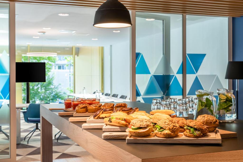 a long table filled with sandwiches and other foods at Holiday Inn Express Amsterdam - North Riverside by IHG in Amsterdam