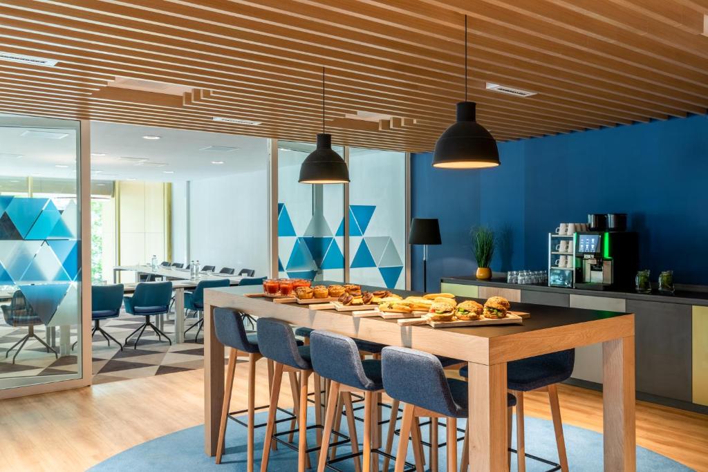 a dining room with a table with fruit on it at Holiday Inn Express Amsterdam - North Riverside by IHG in Amsterdam