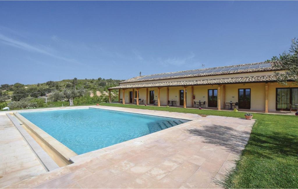 a swimming pool in front of a house at Oriental Muti in Chiaramonte Gulfi