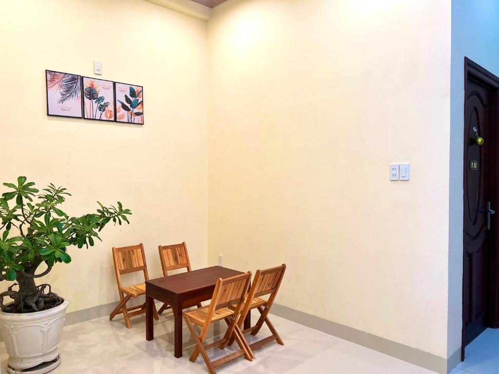 a dining room with a table and chairs at T's House Motel in Ấp Bình Hưng