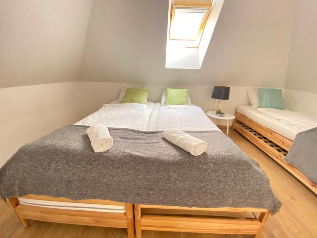 A bed or beds in a room at Dandelion "Zsálya" Vendégház