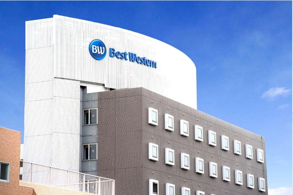 a building with a blue best western sign on it at Best Western Osaka Tsukamoto in Osaka