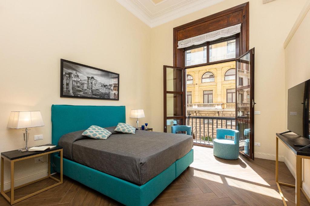 a bedroom with a bed and a large window at SPA Apartment Via Barberini in Rome