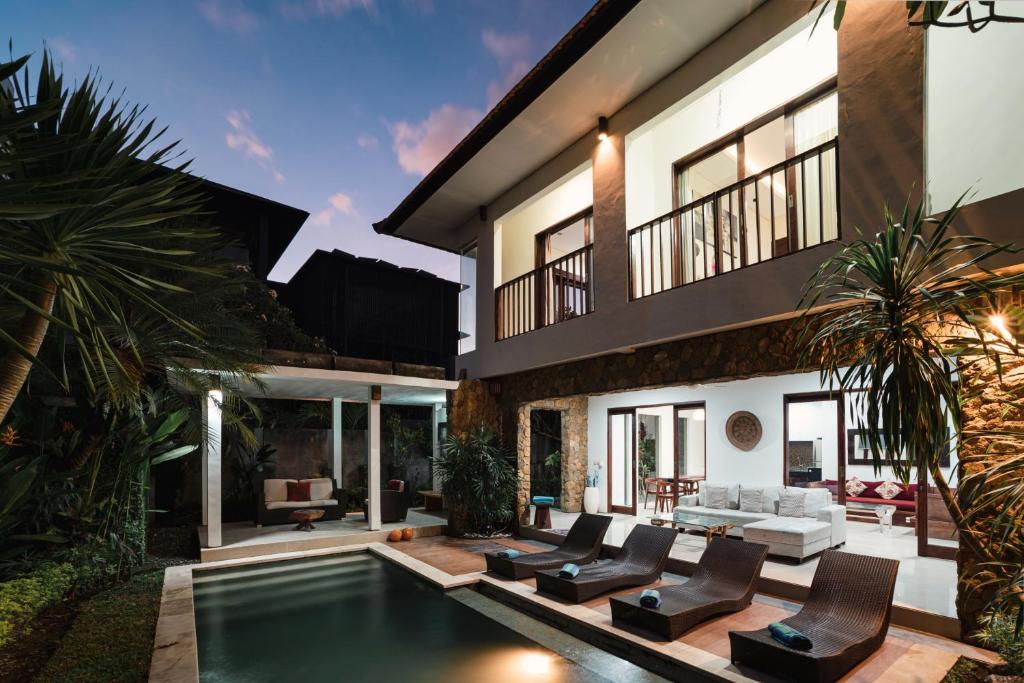 a house with a swimming pool in front of it at Villa C31 Seminyak in Seminyak