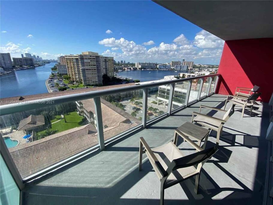 a balcony with chairs and a view of the water at 1 BD 1 BA @Beachwalk Resort in Hallandale Beach