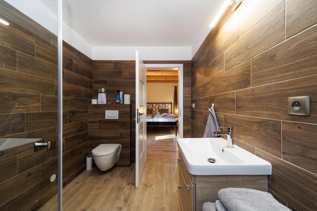 a bathroom with a sink and a toilet at Letovisko Chobot - village resort in Kácov