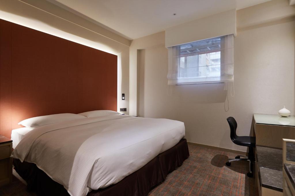 Postel nebo postele na pokoji v ubytování K Hotels Taipei Linsen