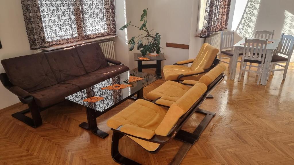 a living room with two chairs and a couch at Risto Apartment in Skopje