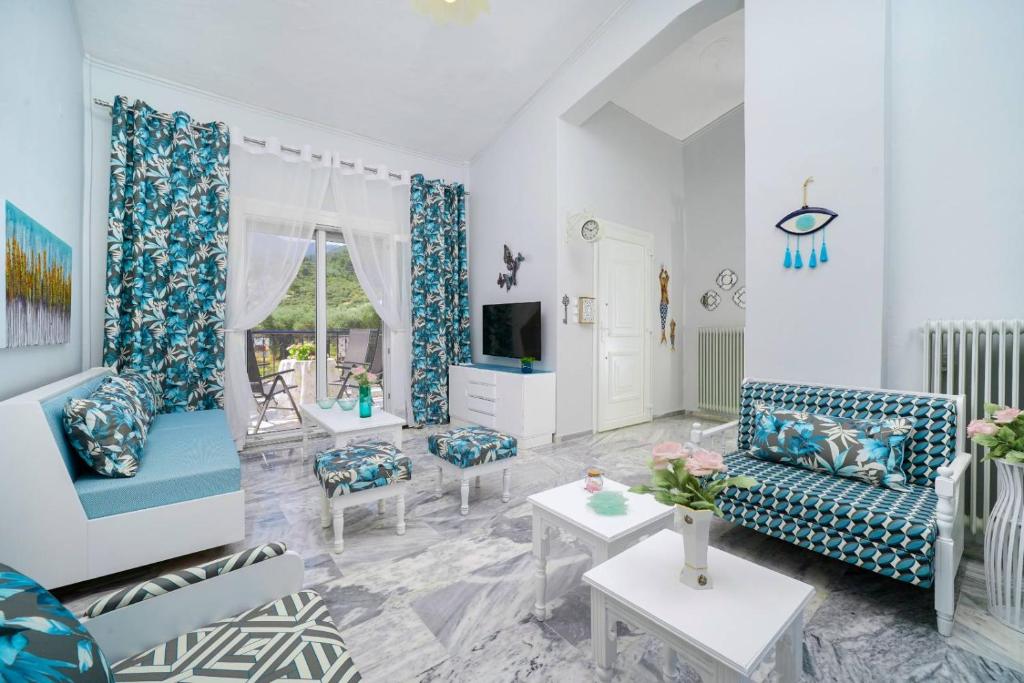 sala de estar con muebles azules y blancos en yiayia and papou Luxury House, en Limenas