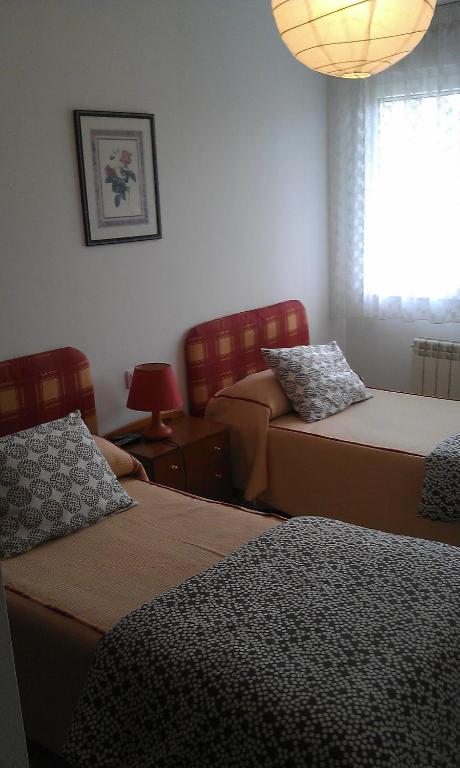 Postel nebo postele na pokoji v ubytování Pensión Residencia Miñones