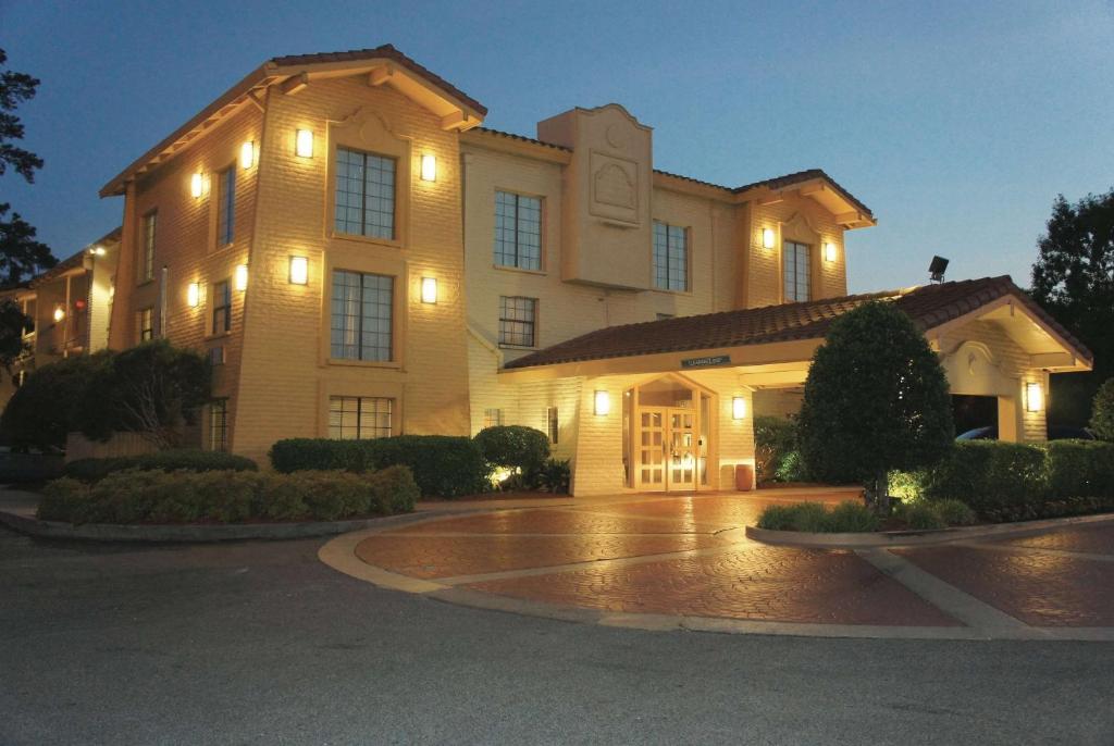 a large building with lights in a parking lot at Days Inn by Wyndham Augusta Washington Rd in Augusta