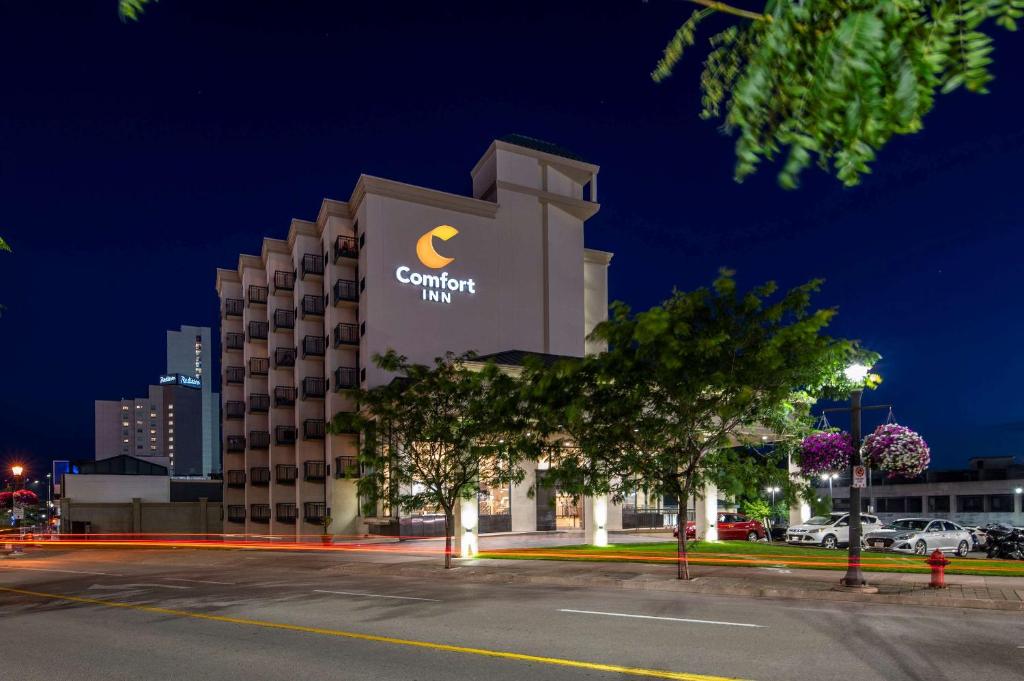 a building with a cambria hotel at night at Comfort Inn Fallsview in Niagara Falls