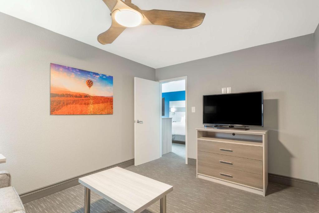 a living room with a flat screen tv at Best Western Plus Magnolia Inn & Suites in Cleveland