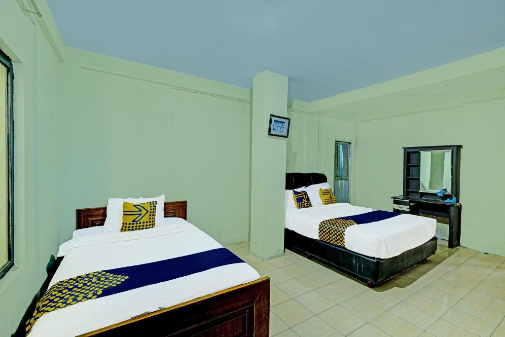 Postel nebo postele na pokoji v ubytování SPOT ON 91540 Ukuh Guesthouse