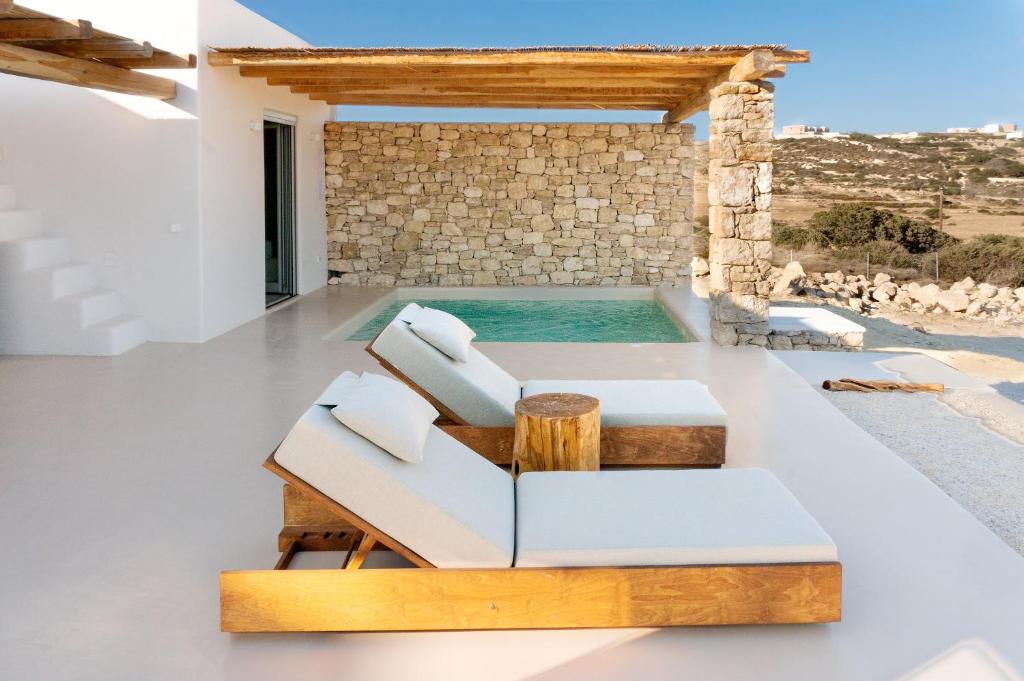 a living room with a couch and a swimming pool at Mystic Villas Koufonisi in Koufonisia