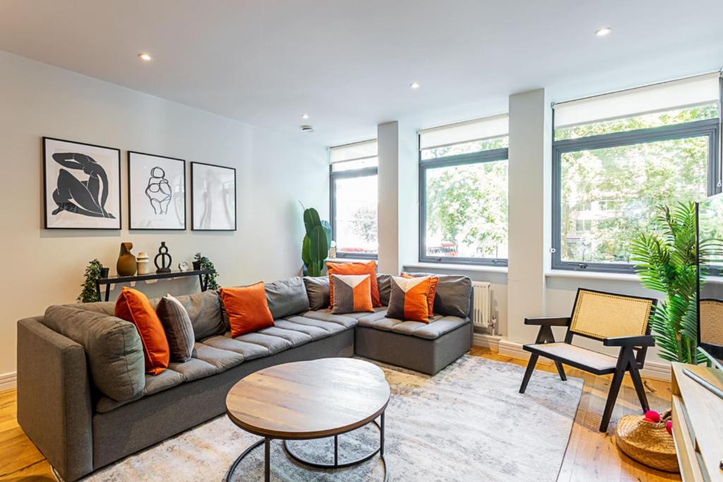 a living room with a couch and a table at Stunning Modern Apartment in the Heart of Holborn in London