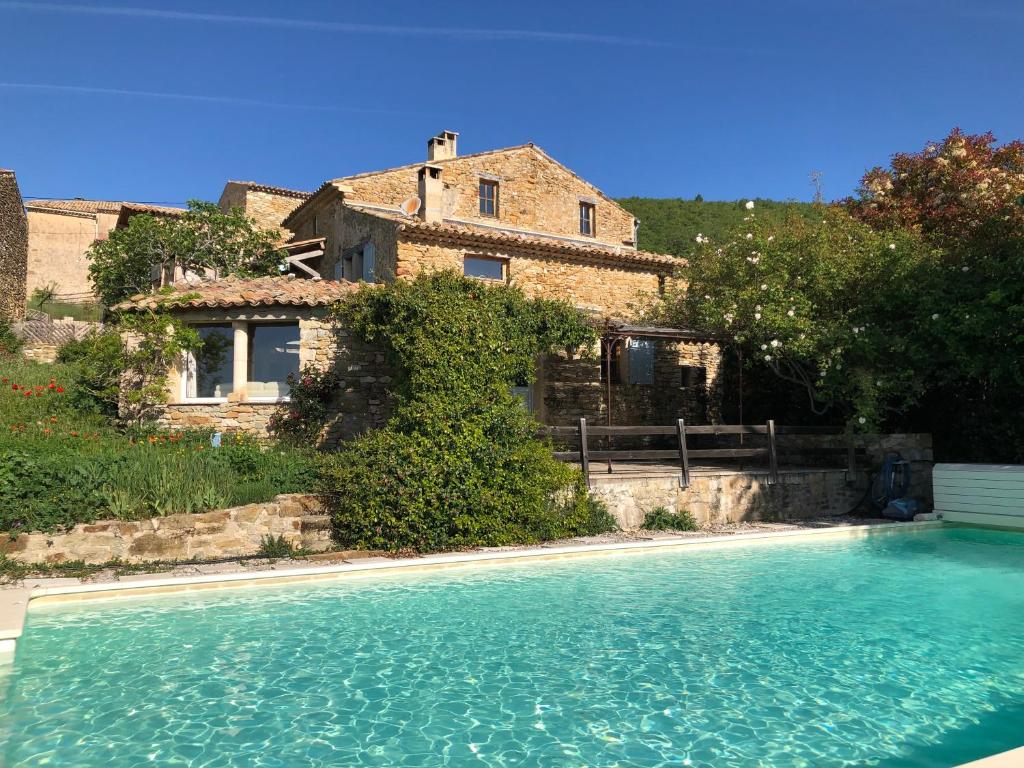 a house and a swimming pool in front of a house at L'Arbre d'Alice in Ongles