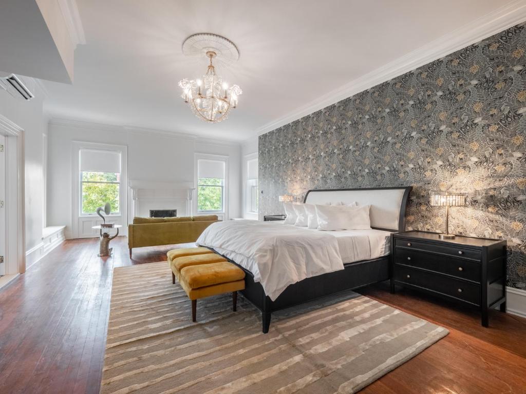 a bedroom with a large bed and a chandelier at Graystone Inn in Wilmington