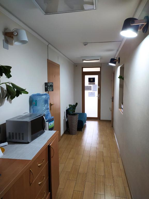 a room with a kitchen with a microwave on a counter at Hotel Trias in Kyiv