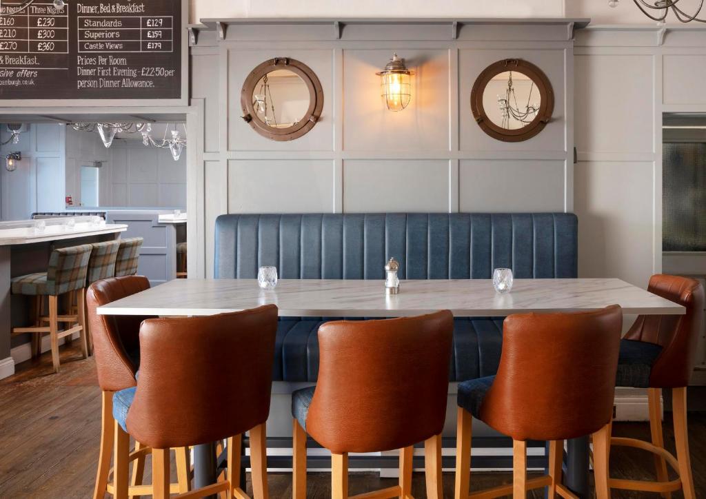 a dining room with a table and chairs at The Victoria Hotel in Bamburgh