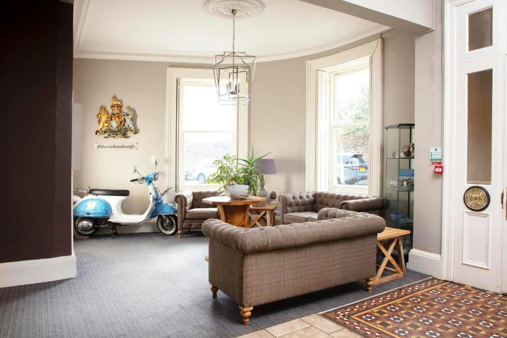 a living room with a couch and a motor scooter at The Victoria Hotel in Bamburgh
