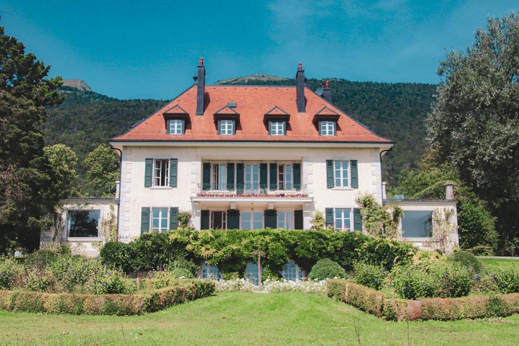 a large house with a red roof at Chateau d'Echenevex - Luxury Escape near Geneva in Échenevex