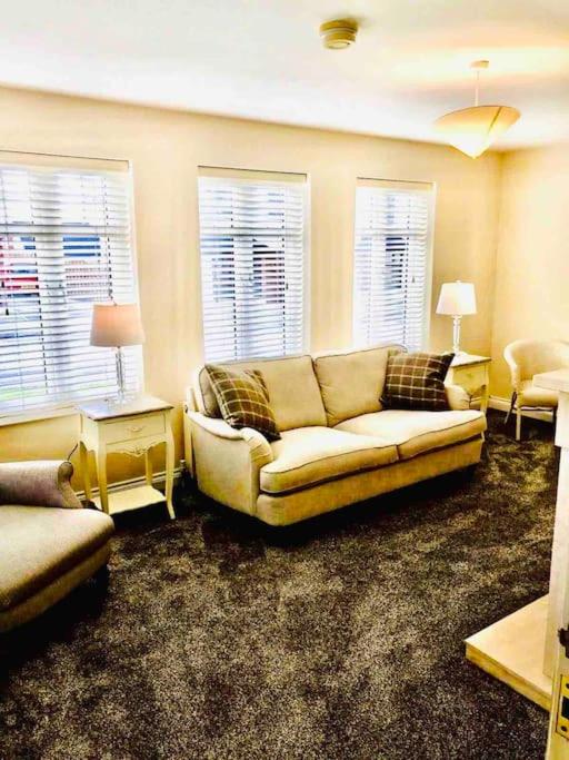 a living room with a couch and two windows at Semi-detached Armagh House in Armagh