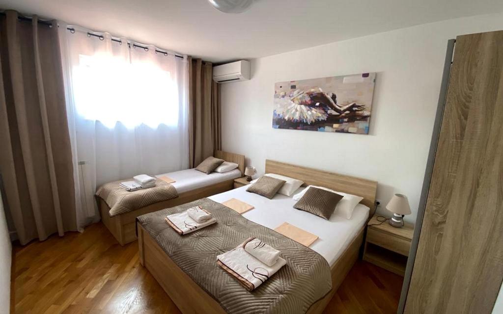 a hotel room with two beds with towels on them at Apartments Villa Bubi in Pula