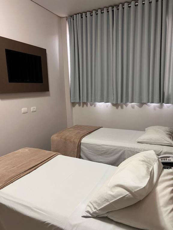Postel nebo postele na pokoji v ubytování Hotel Cadori
