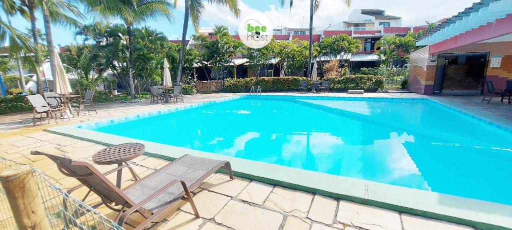 una piscina con 2 tumbonas y un hotel en COPDS0104 - Tranquilidade em condomínio particular, en Salvador